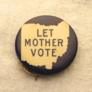 A pin given out by the Ohio Women's Suffrage Association in 1911. It shows the outline of the state of Ohio, and inside are the words "Let Mother Vote."